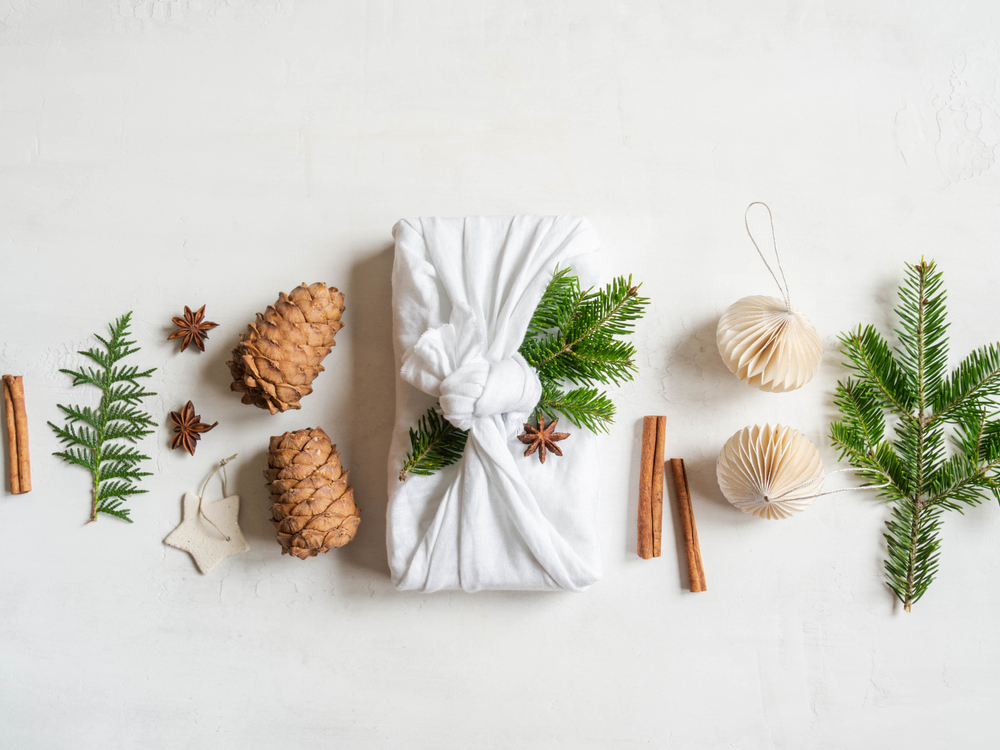 Image of recycled Christmas decorations including greenery on a white background.